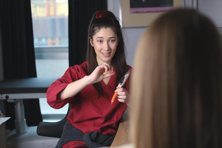 A nurse gives health advice to a patient