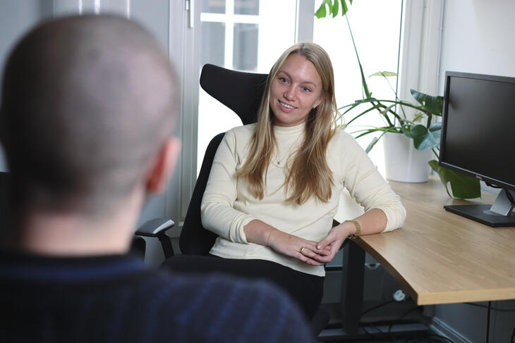 A social worker speaking to a service user